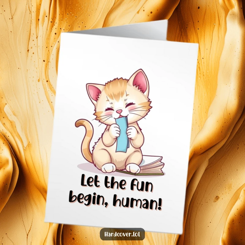 Funny free printable birthday card featuring a mischievous kitten playing with a bookmark dangling from a book.